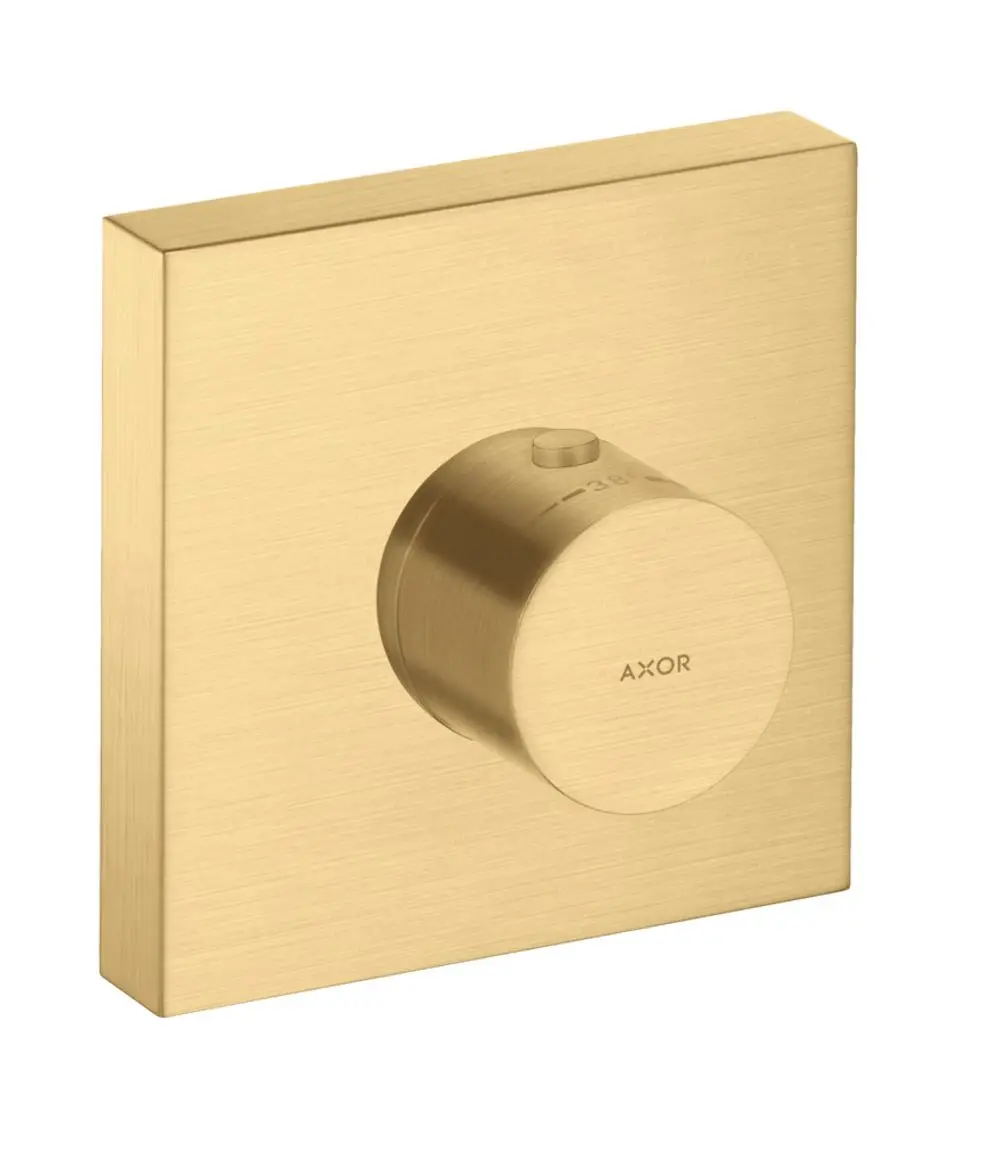 Thermostatmodul mit runder Drehknopfsteuerung auf quadratischem, gebürstetem Gold-Hintergrund. Markierung für Temperatur. Produkt der Marke AXOR.